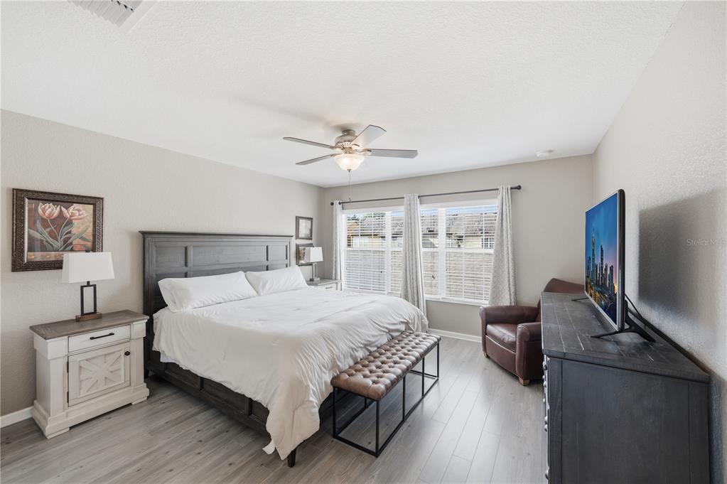 7712 Moser Avenue Windermere, FL 34786 - Photo 17 of 30 a bedroom with a bed and a flat screen tv