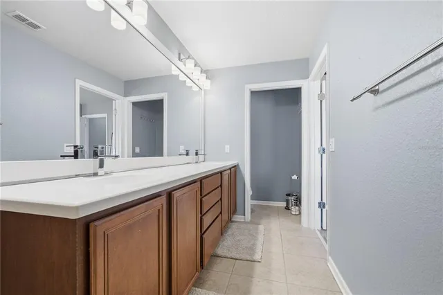 a bathroom with a sink a vanity and a mirror