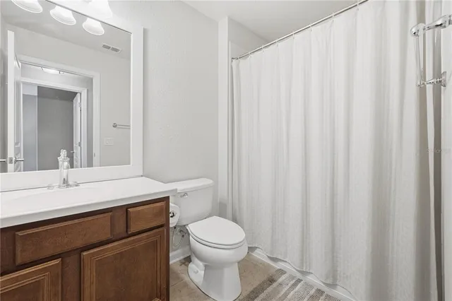 a bathroom with a toilet a sink and a mirror