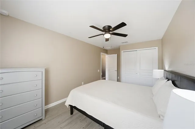 a bedroom with a large bed and a chandelier