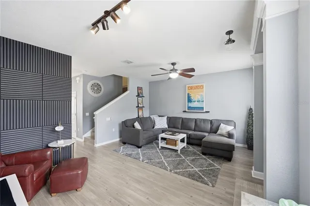 a living room with couches and painting on the wall