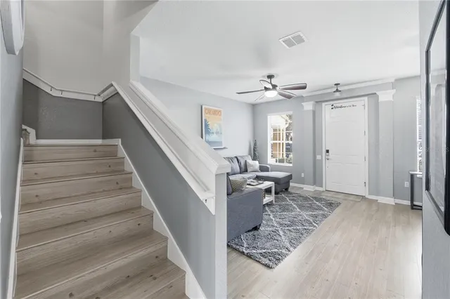 a view of entryway and hall with wooden floor