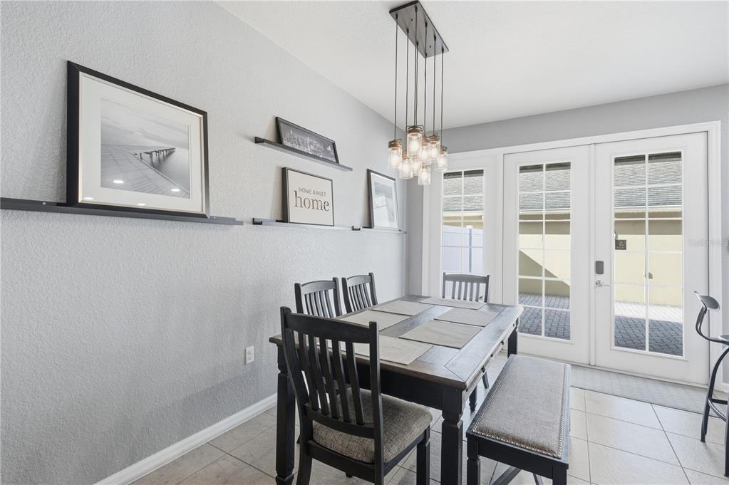 7712 Moser Avenue Windermere, FL 34786 - Photo 9 of 30 a view of a dining room with furniture large window and wooden floor