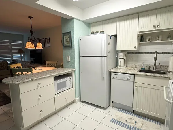a kitchen with a stove a refrigerator and a sink