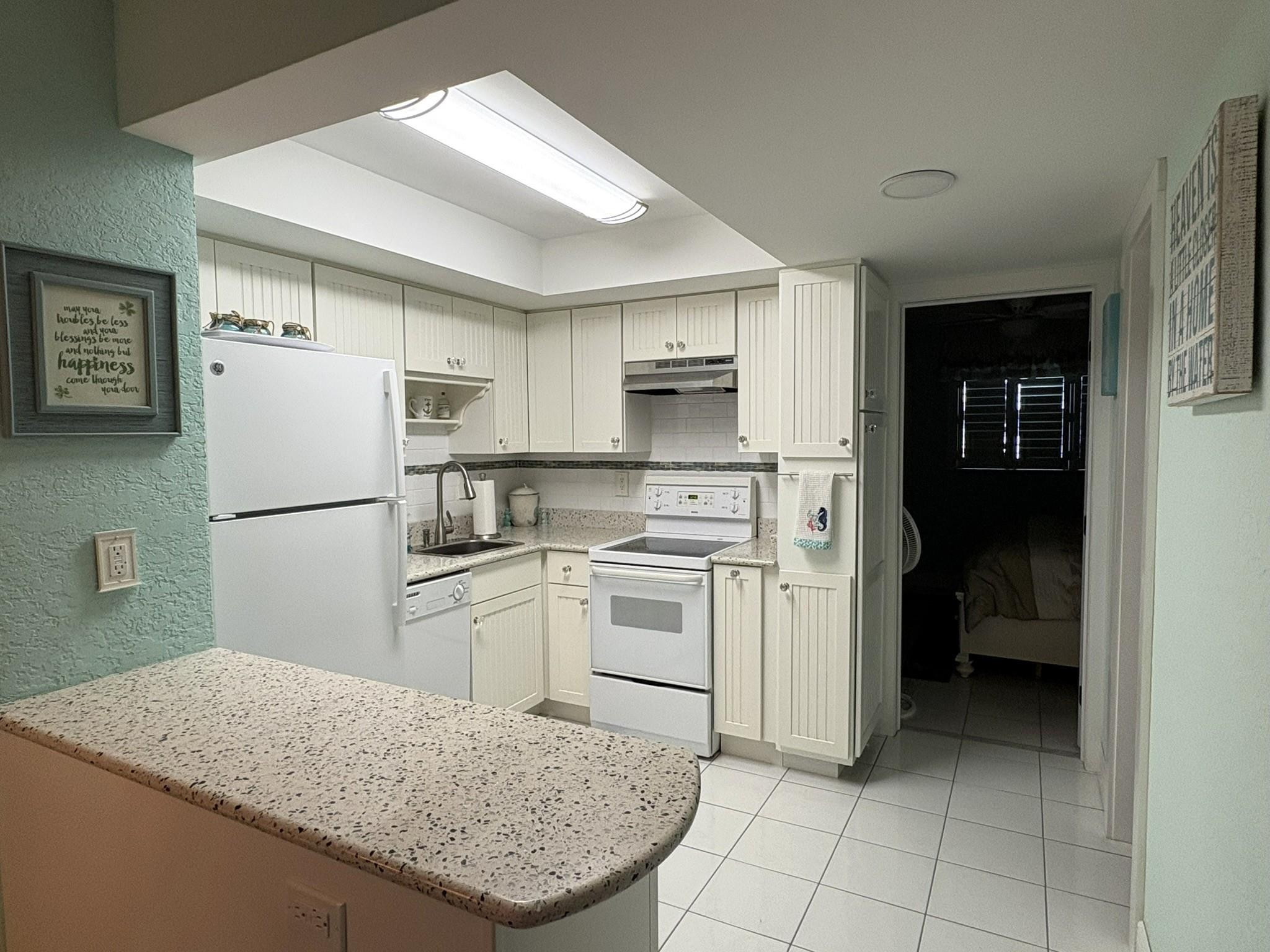 1201 North Riverside Drive, Unit 12B Pompano Beach, FL 33062 - Photo 12 of 63 a kitchen with a stove a refrigerator and a sink