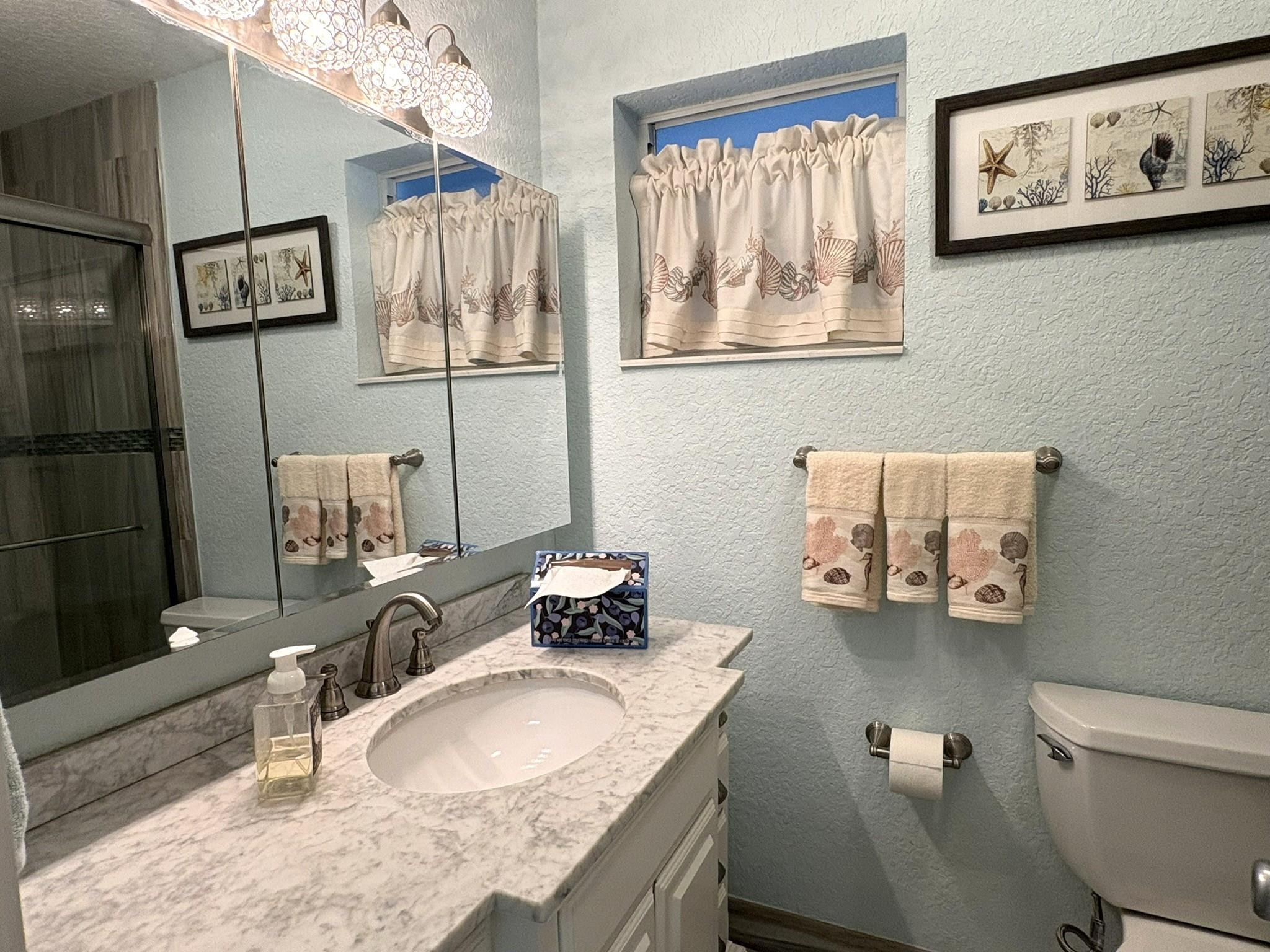 1201 North Riverside Drive, Unit 12B Pompano Beach, FL 33062 - Photo 14 of 63 a bathroom with a granite countertop sink a mirror and a toilet