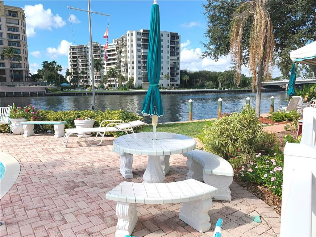 1201 North Riverside Drive, Unit 12B Pompano Beach, FL 33062 - Photo 17 of 63 a view of a lake with a patio table and chairs