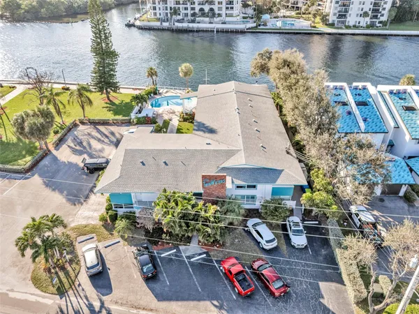 an aerial view of a house with swimming pool and outdoor seating