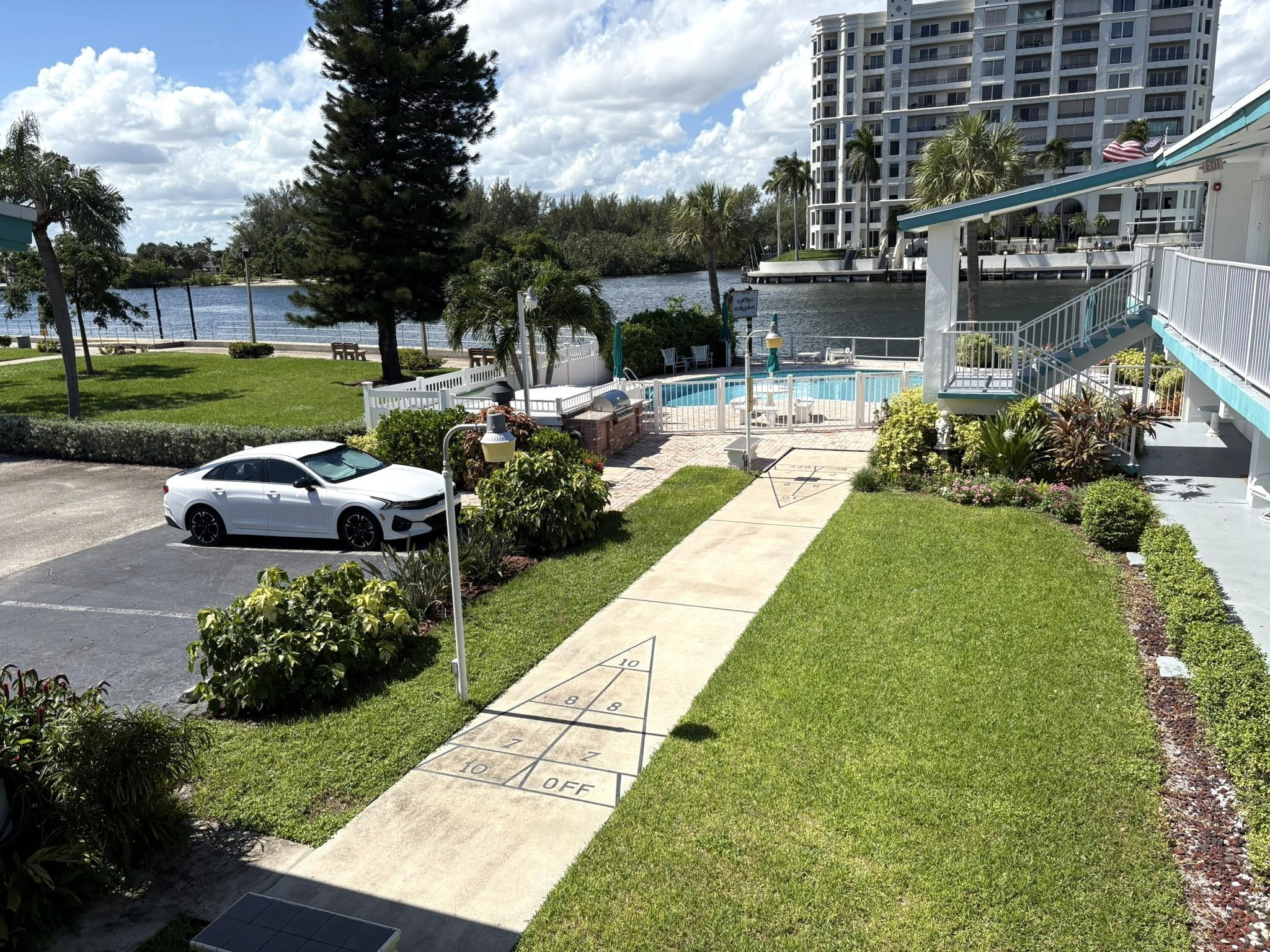 1201 North Riverside Drive, Unit 12B Pompano Beach, FL 33062 - Photo 37 of 63 a swimming pool with barbeque oven outdoor seating and green space