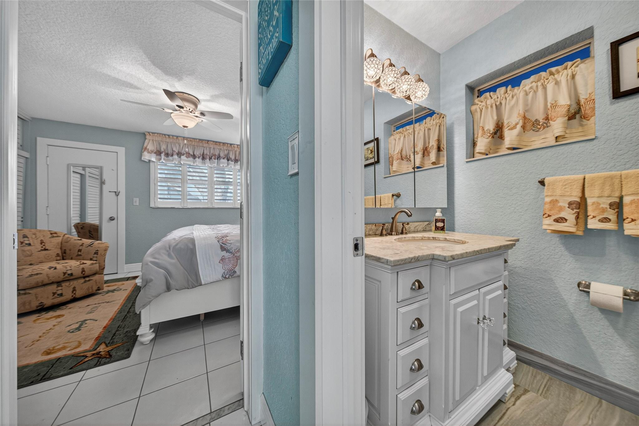 1201 North Riverside Drive, Unit 12B Pompano Beach, FL 33062 - Photo 39 of 63 a en suite bathroom with a double vanity sink and a mirror