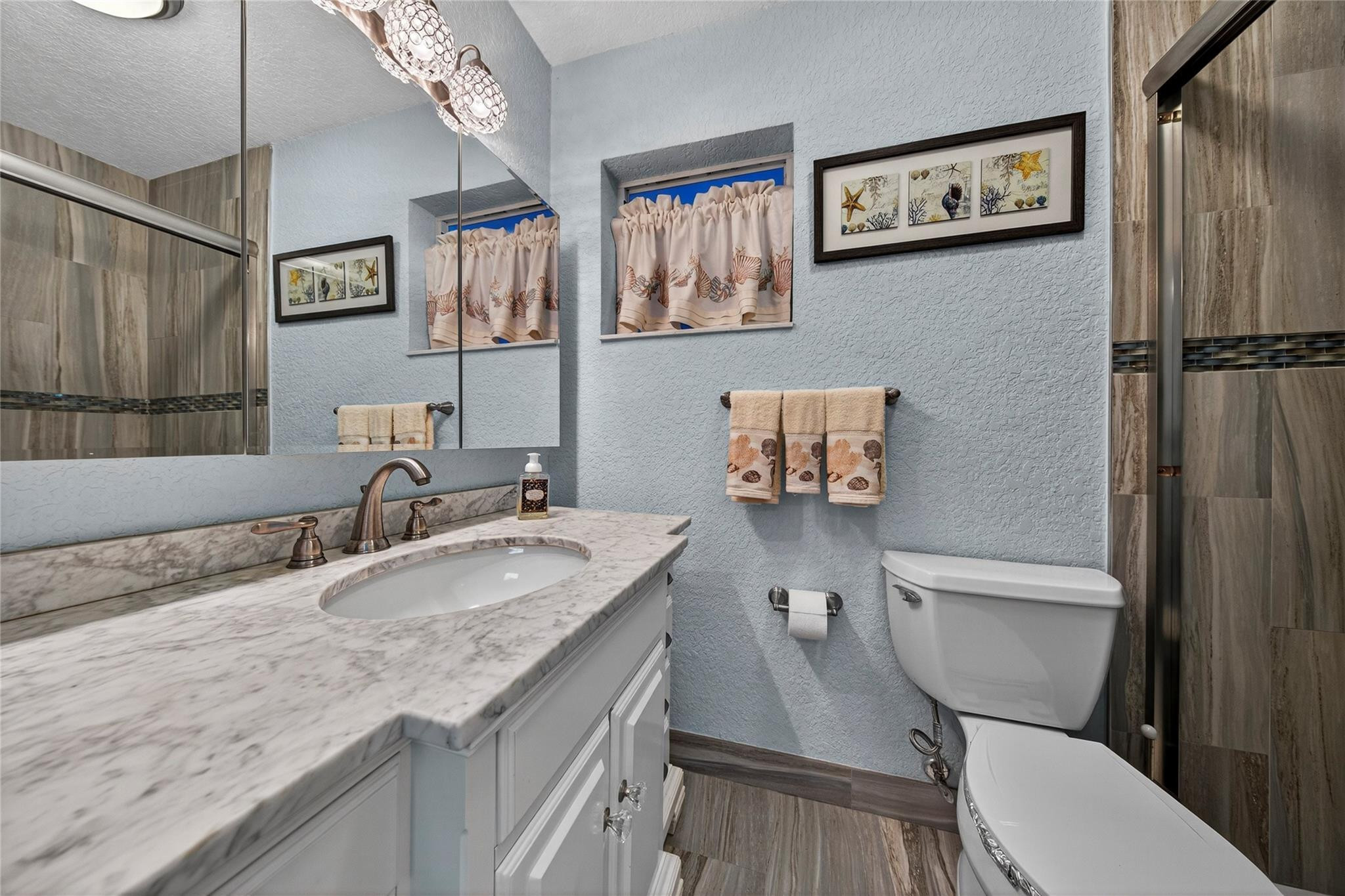 1201 North Riverside Drive, Unit 12B Pompano Beach, FL 33062 - Photo 44 of 63 a bathroom with a granite countertop toilet sink and mirror