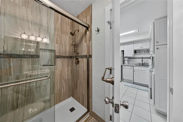 a kitchen with a refrigerator sink and cabinets