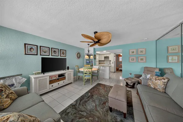 a kitchen with a refrigerator a stove top oven and cabinets