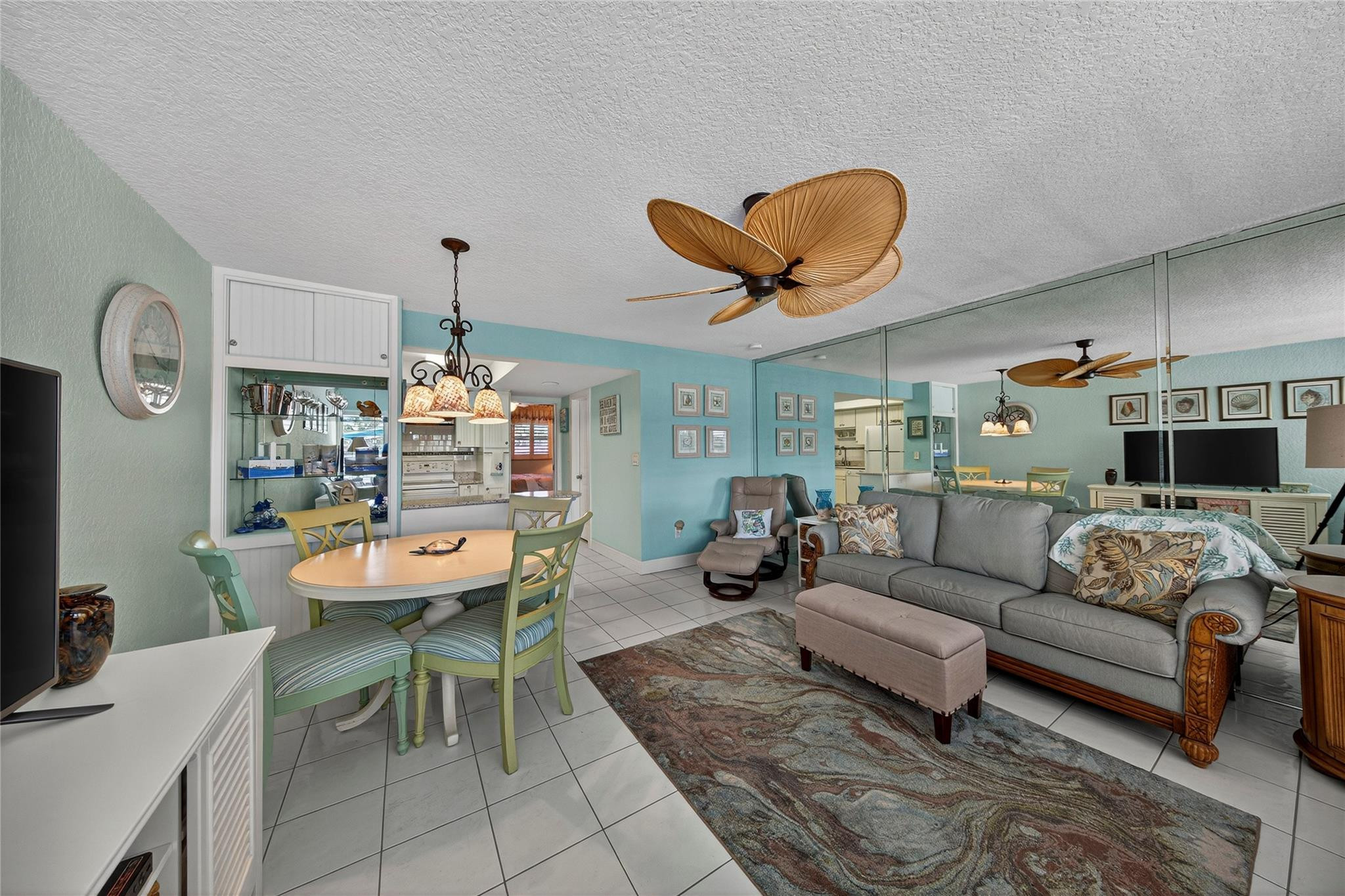 1201 North Riverside Drive, Unit 12B Pompano Beach, FL 33062 - Photo 48 of 63 a living room with furniture and a chandelier