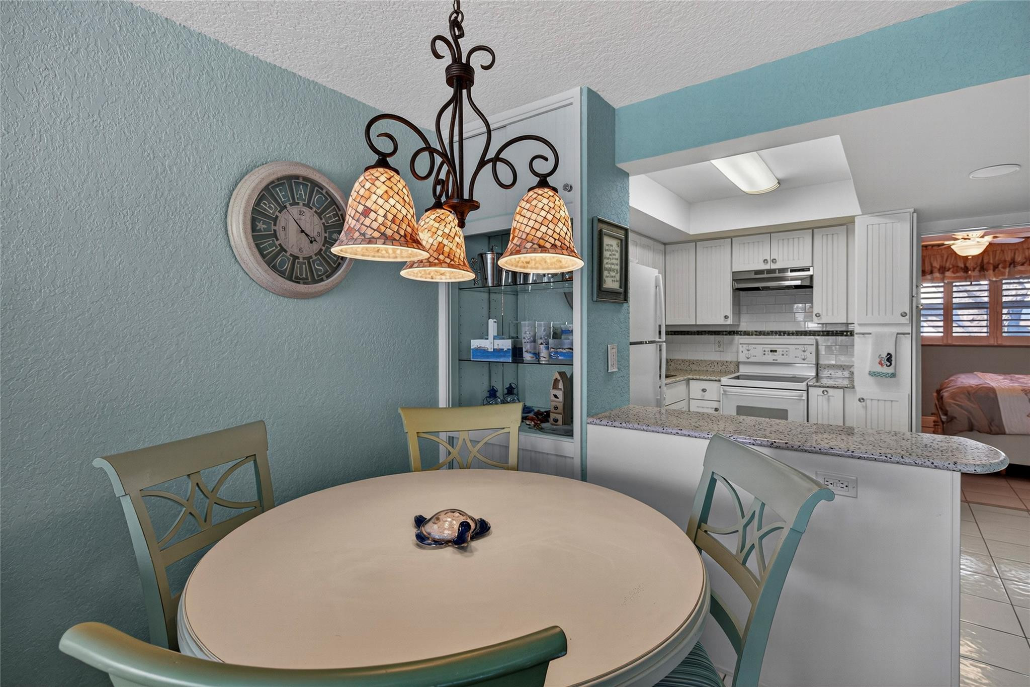 1201 North Riverside Drive, Unit 12B Pompano Beach, FL 33062 - Photo 52 of 63 a view of a dining room with furniture a kitchen and chandelier