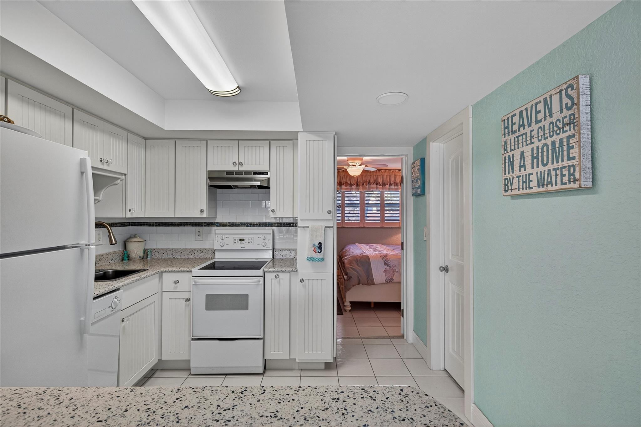 1201 North Riverside Drive, Unit 12B Pompano Beach, FL 33062 - Photo 54 of 63 a kitchen with a refrigerator sink and cabinets