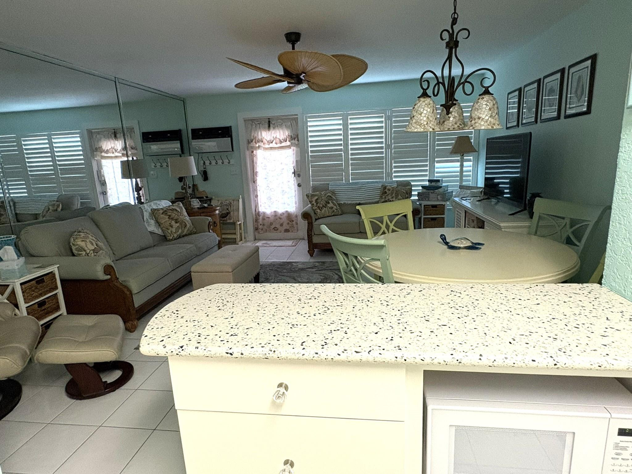 1201 North Riverside Drive, Unit 12B Pompano Beach, FL 33062 - Photo 10 of 63 a living room with furniture and a chandelier