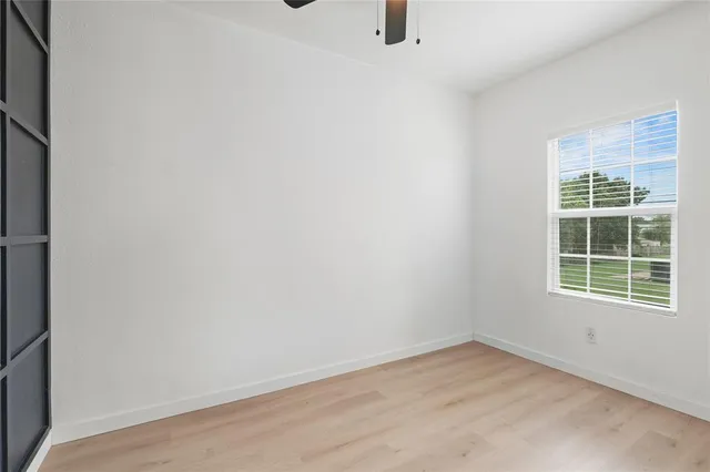 a view of backyard with wooden fence