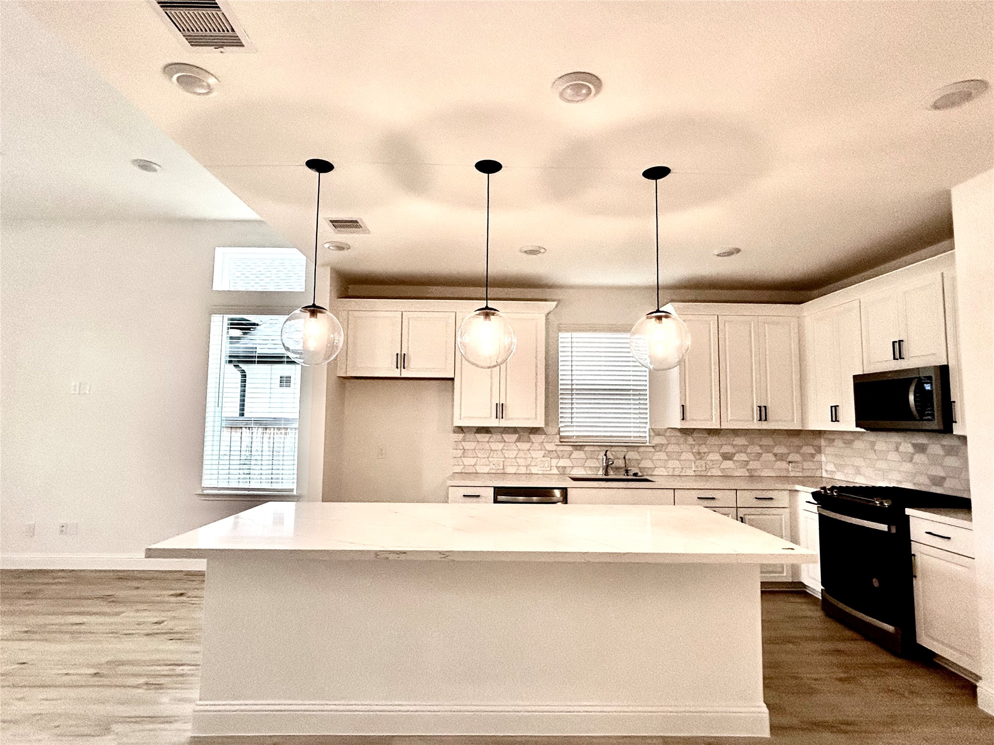 15310 Spanish Ranchos Way, Unit WAYS Cypress, TX 77433 - Photo 12 of 40 Pendant lights over the kitchen island