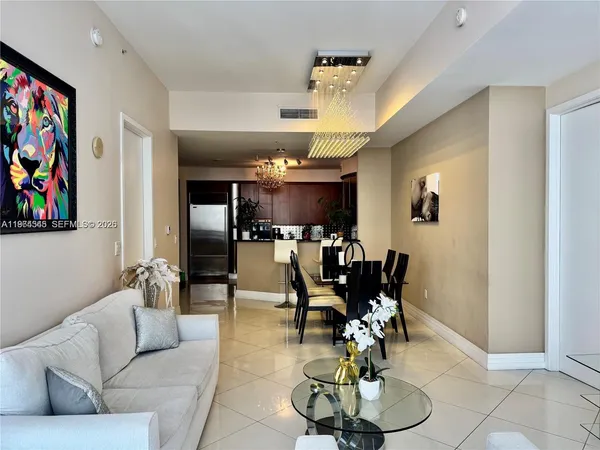a living room with furniture and kitchen view