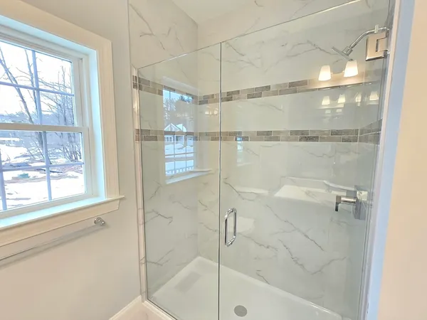 a bathroom with a glass shower door