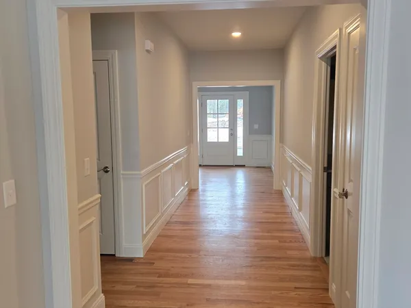 a view of a hallway with wooden floor