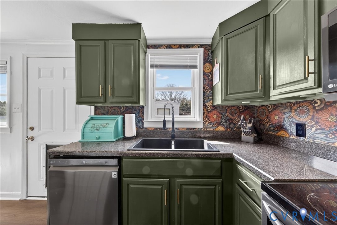8427 Pamunkey Road Spotsylvania, VA 22551 - Photo 12 of 50 a kitchen with granite countertop a sink and cabinets
