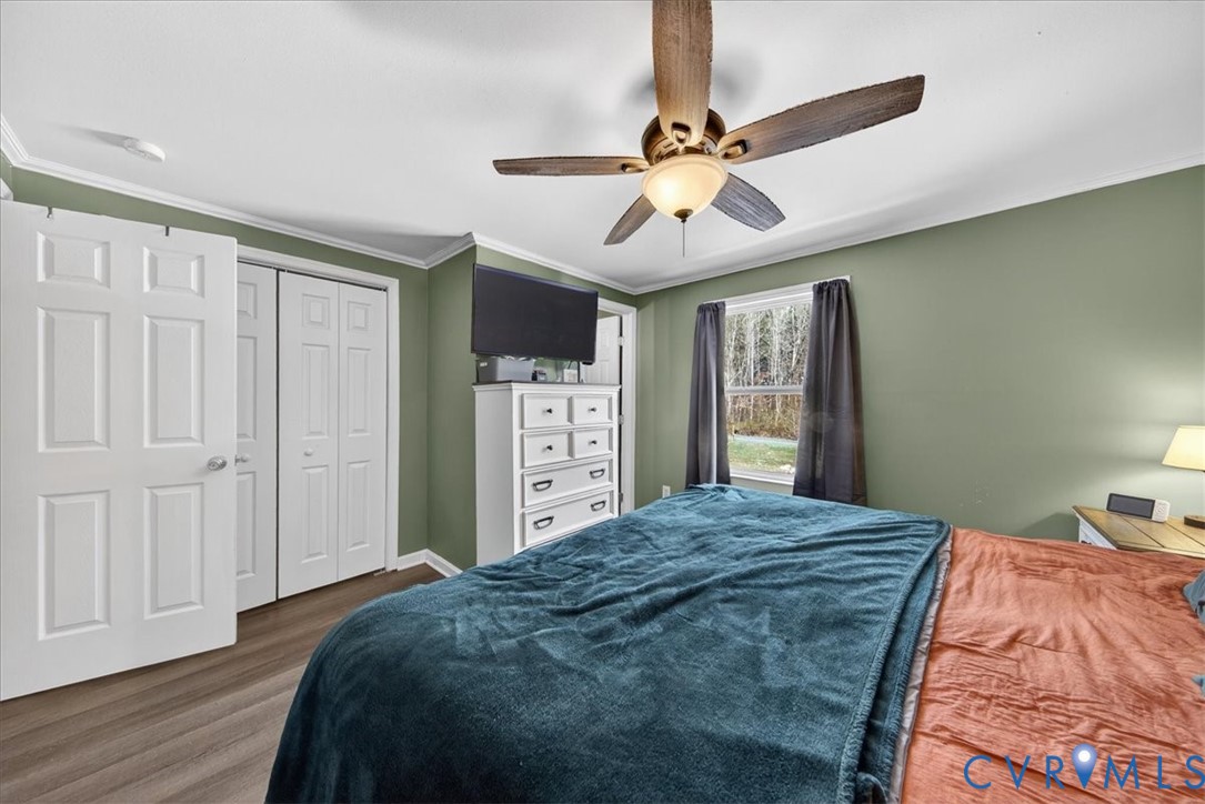 8427 Pamunkey Road Spotsylvania, VA 22551 - Photo 19 of 50 a bedroom with a large bed and a chandelier