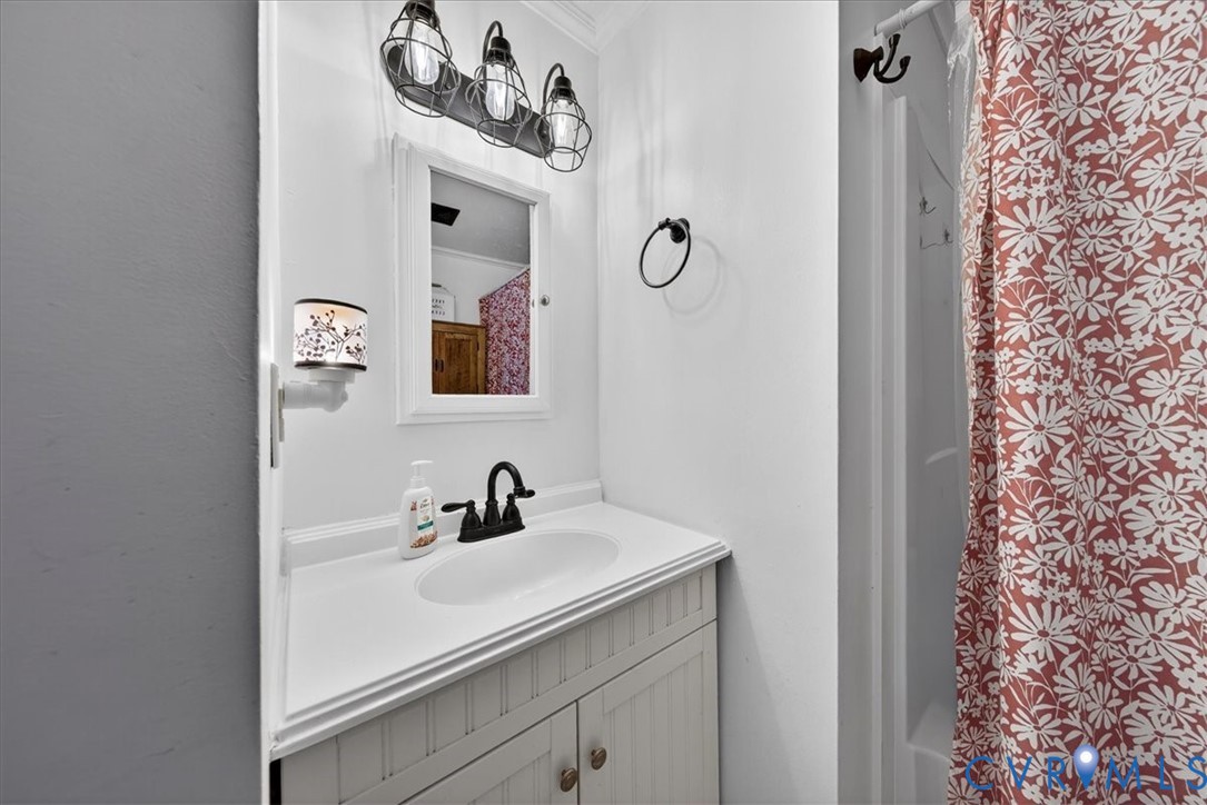 8427 Pamunkey Road Spotsylvania, VA 22551 - Photo 20 of 50 a bathroom with a sink and a mirror