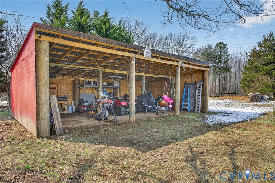 8427 Pamunkey Road Spotsylvania, VA 22551 - Photo 31 of 50 a view of a garage with a bike and car