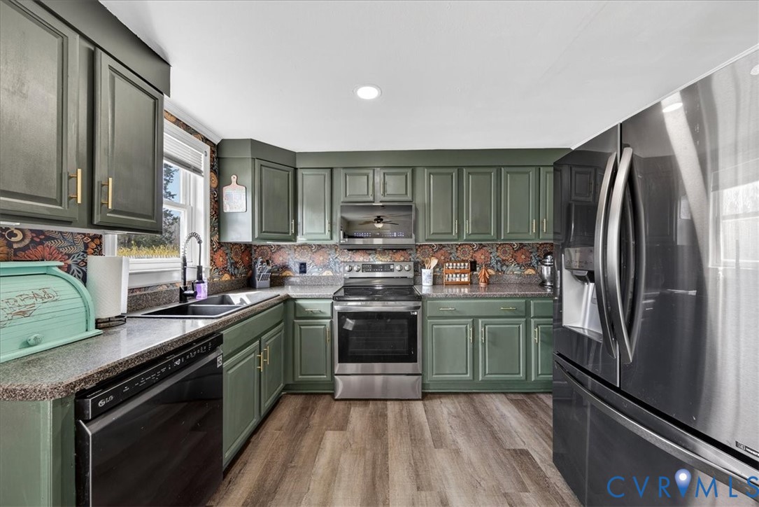 8427 Pamunkey Road Spotsylvania, VA 22551 - Photo 10 of 50 a kitchen with stainless steel appliances granite countertop a sink stove and refrigerator