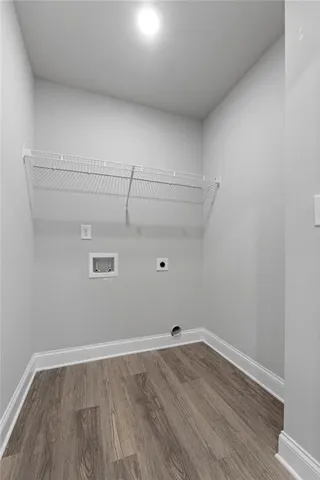 a view of a room with wooden floor