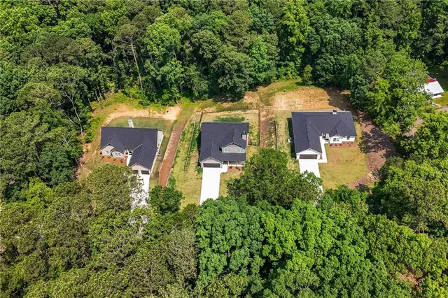 an aerial view of a house with a yard