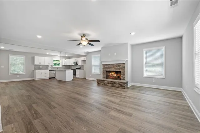 a view of empty room with wooden floor and fireplace