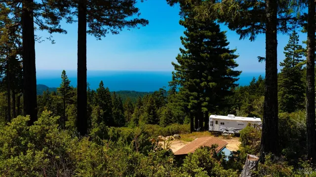 a view of a patio with lawn chairs under an umbrella