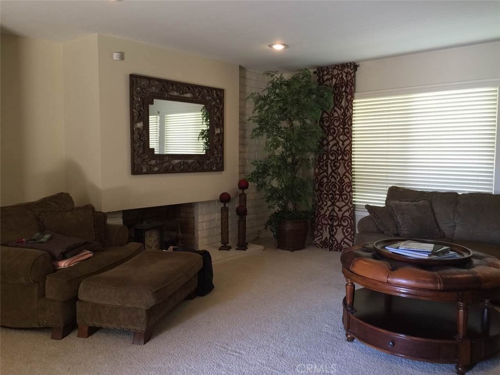 2725 Firethorne Avenue Fullerton, CA 92835 - Photo 4 of 9 a living room with furniture and a flat screen tv