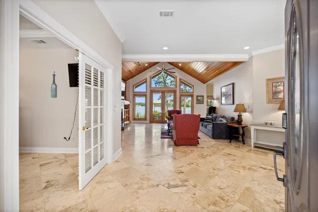 a dining room with furniture a chandelier and window