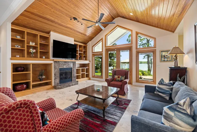 a spacious bedroom with a bed a couch and a flat tv screen on the dresser