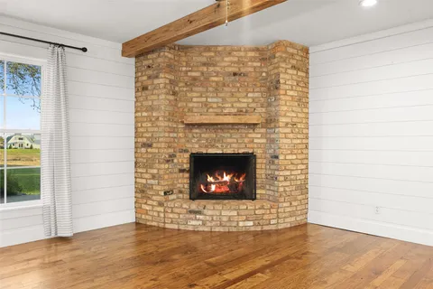a view of an empty room and fire place