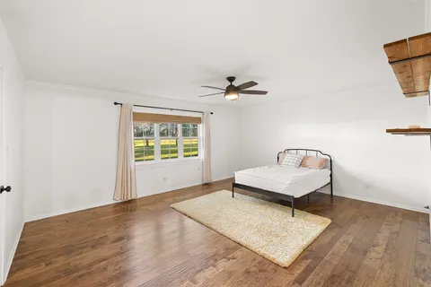 a living room with a bed furniture and a window