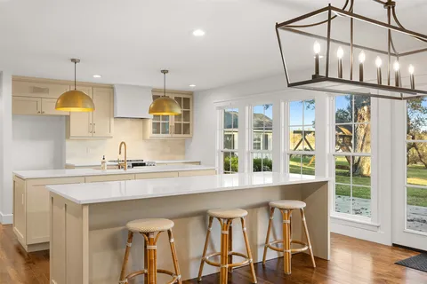 a kitchen with stainless steel appliances granite countertop a stove a sink dishwasher and cabinets with wooden floor