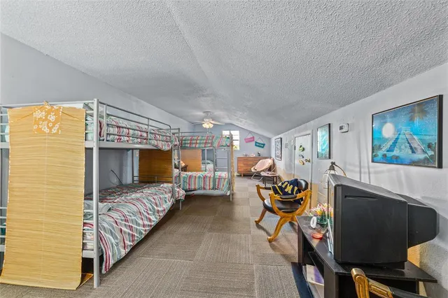 a bedroom with furniture and a flat screen tv