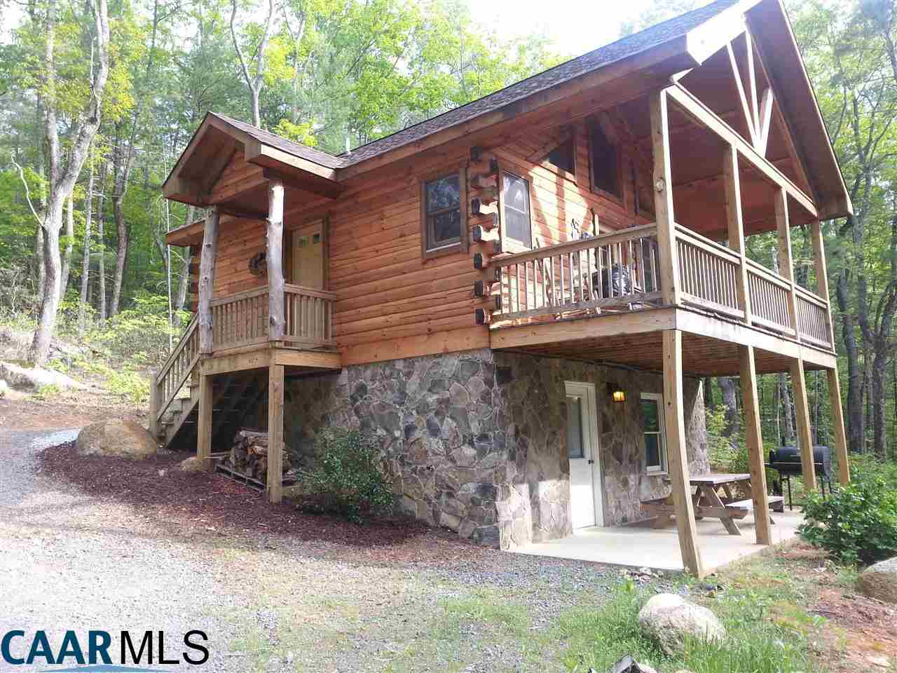1673 Turkey Ridge Road Stanardsville, VA 22973 - Photo 1 of 12 a front view of a house with garden