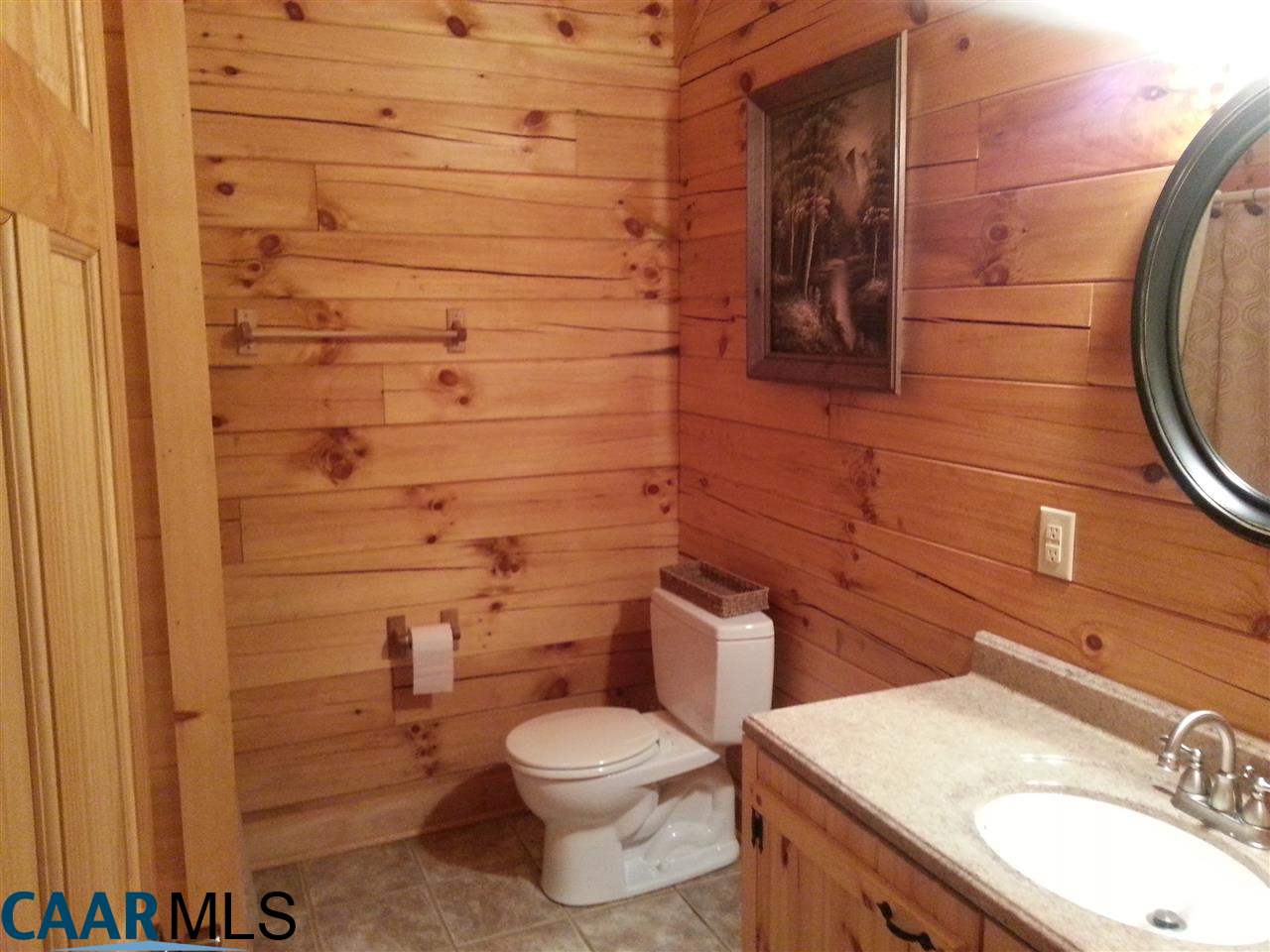 1673 Turkey Ridge Road Stanardsville, VA 22973 - Photo 4 of 12 a bathroom with a granite countertop toilet sink and mirror