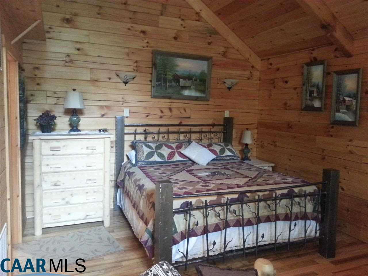 1673 Turkey Ridge Road Stanardsville, VA 22973 - Photo 5 of 12 a bedroom with a bed and a wooden floor