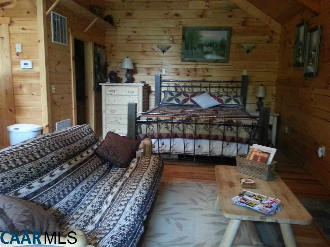1673 Turkey Ridge Road Stanardsville, VA 22973 - Photo 8 of 12 a bedroom with a bed and a fireplace