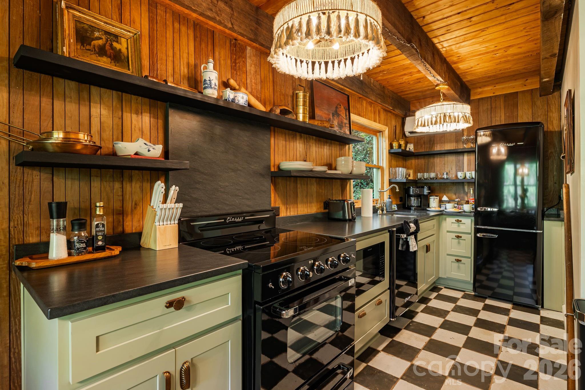 155 Spivey Mountain Road Asheville, NC 28806 - Photo 2 of 48 a kitchen with a stove and a refrigerator