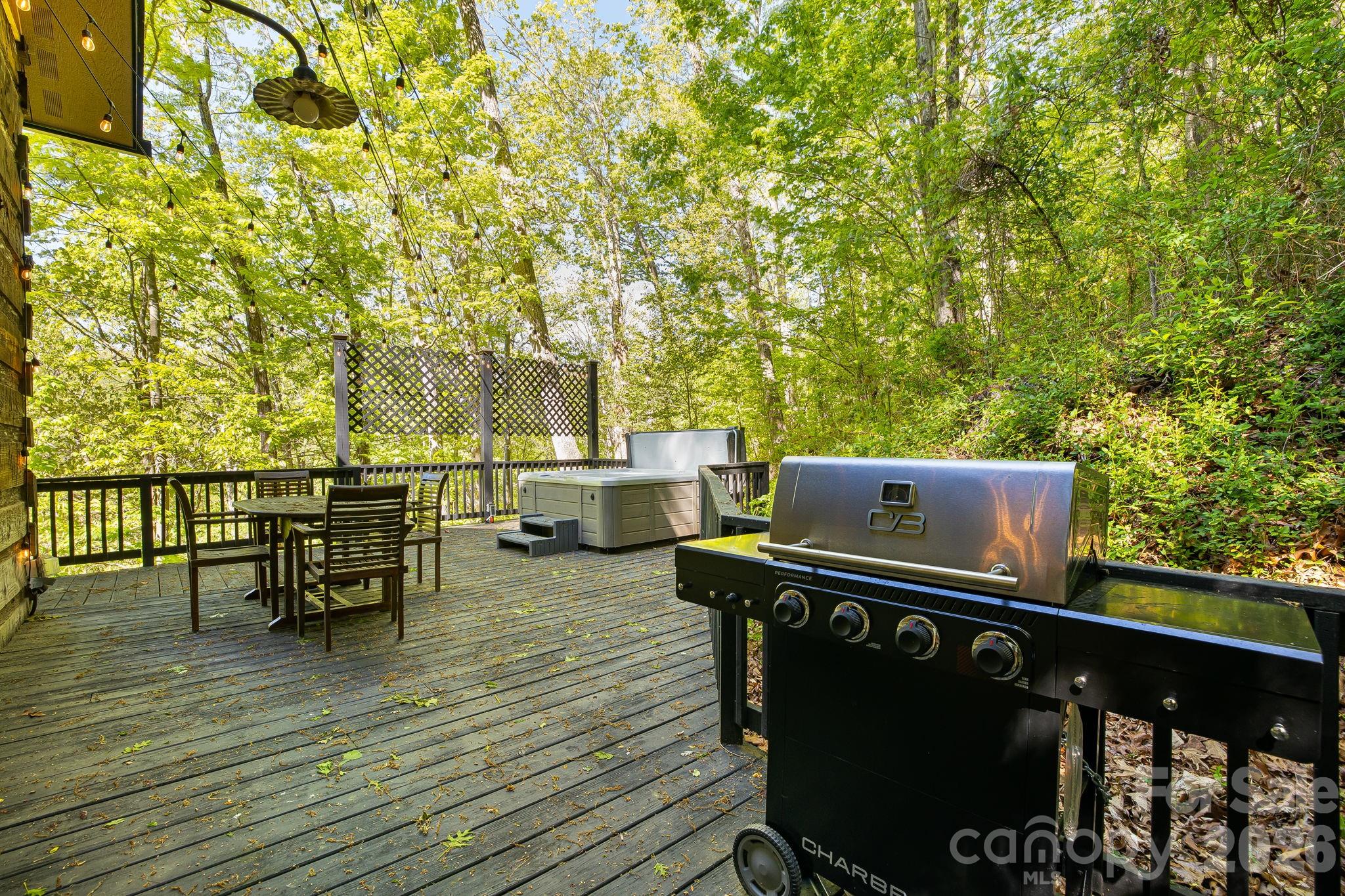 155 Spivey Mountain Road Asheville, NC 28806 - Photo 37 of 48 a view of a roof deck with table and chairs with wooden floor and fence