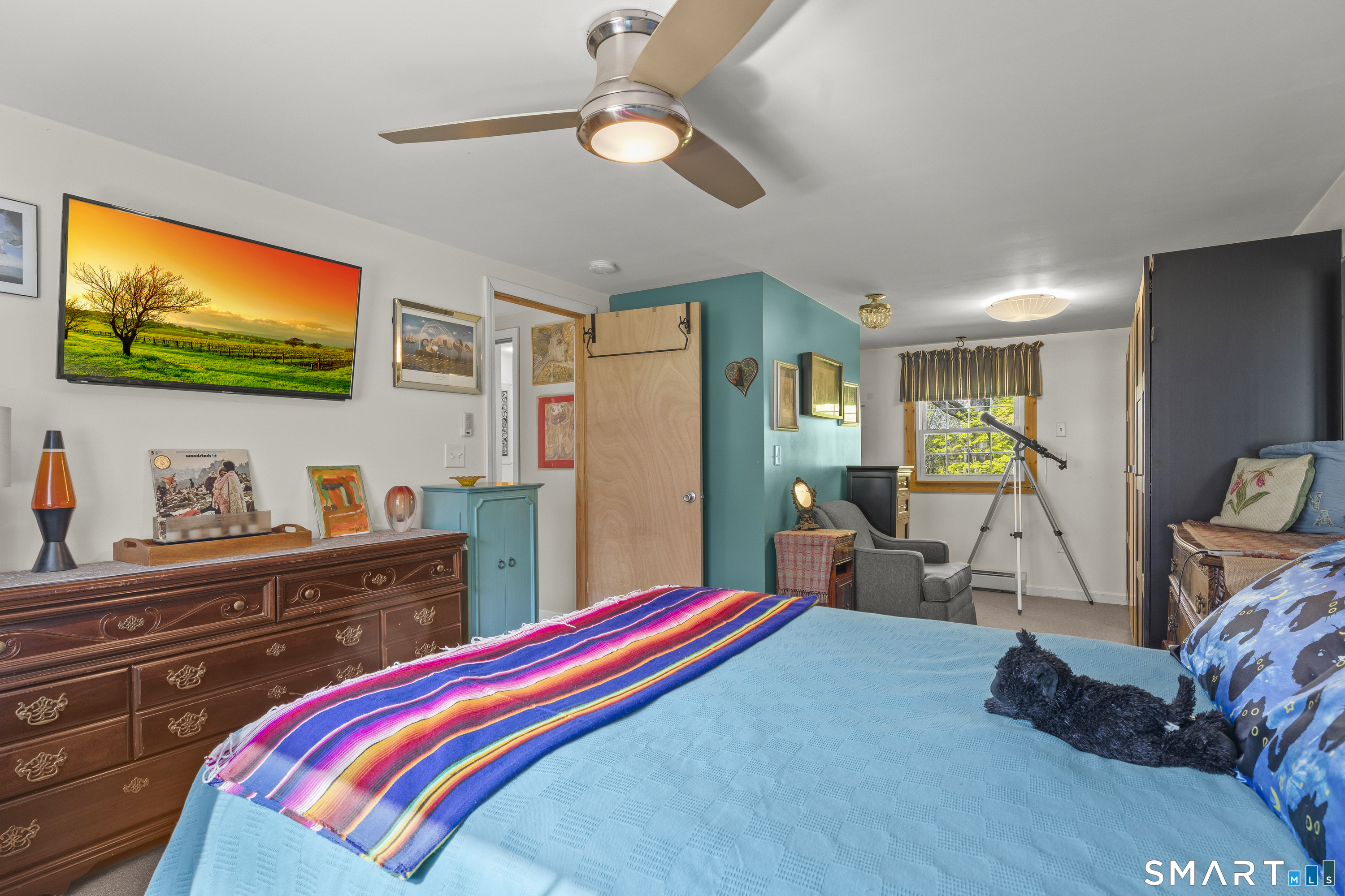 239 Haley Road Ledyard, CT 06339 - Photo 15 of 40 a bedroom with a bed and a flat screen tv