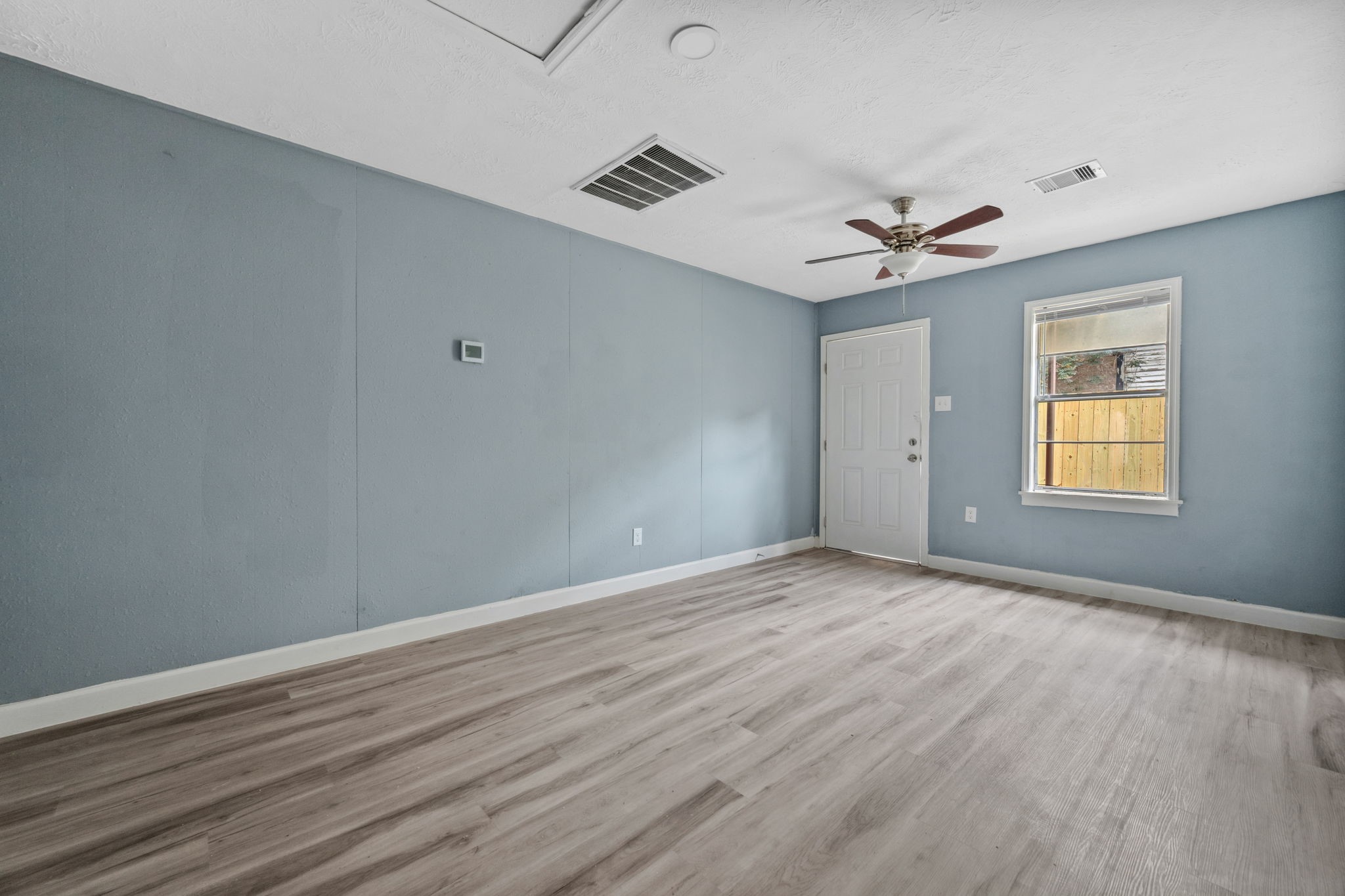 3425 Nettleton Street, Unit 1 Houston, TX 77004 - Photo 2 of 12 wooden floor in an empty room with a window